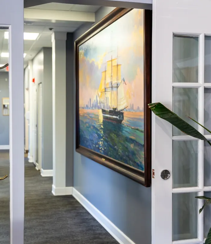 The corridor at Vultaggio Dental, with a large painting of a tall ship.