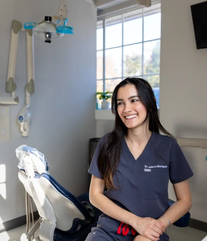 Dr. Juliana Enriquez smiling in a sunlit treatment room.