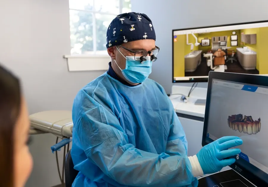 Dr. Stephen Vultaggio reviewing a 3-D digital scan of a patient's teeth on screen.